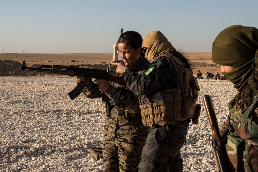 Amara practises shooting during a military drill