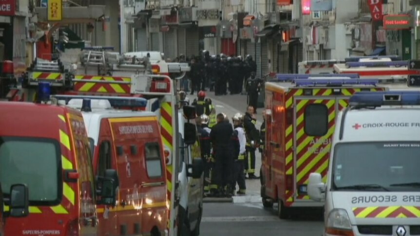 Daylight breaks during an anti-terrorism police raid in Saint Denis, Paris