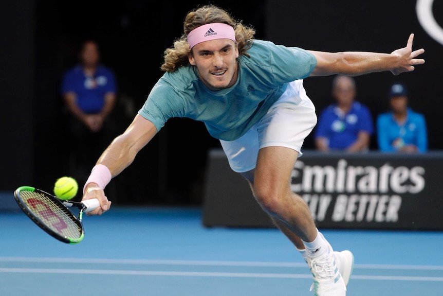 Stefanos Tsitsipas stretches for a forehand against Roger Federer.