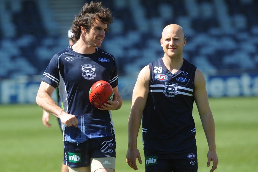 A photo from 2009 of Matthew Scarlett (left) and Gary Ablett Jnr speaking to each other at a Geelong training session.