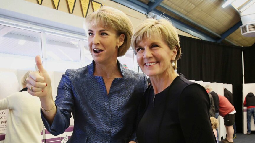 Michaelia Cash gives a thumbs up while posing with Julie Bishop