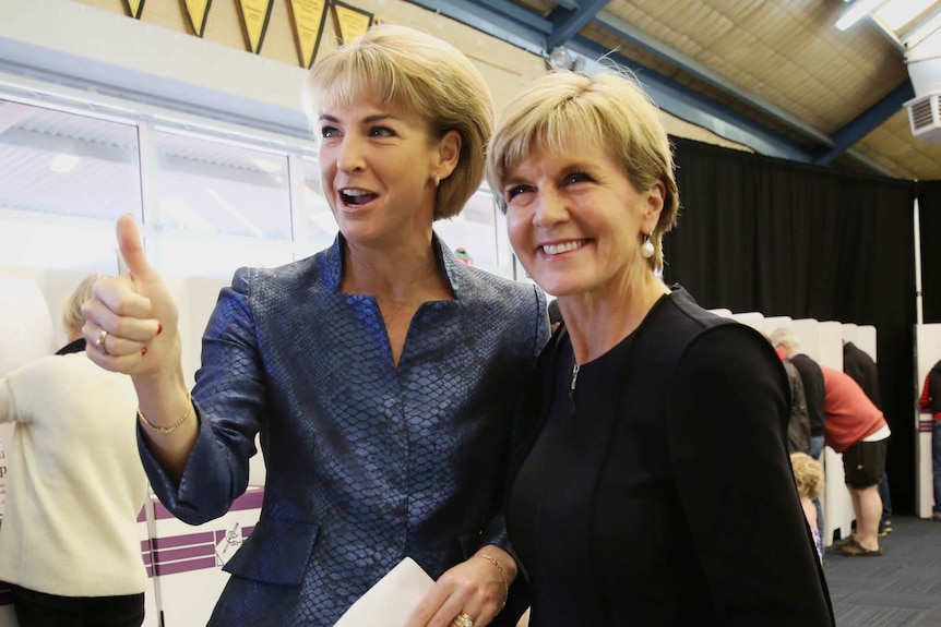 Michaelia Cash gives a thumbs up while posing with Julie Bishop