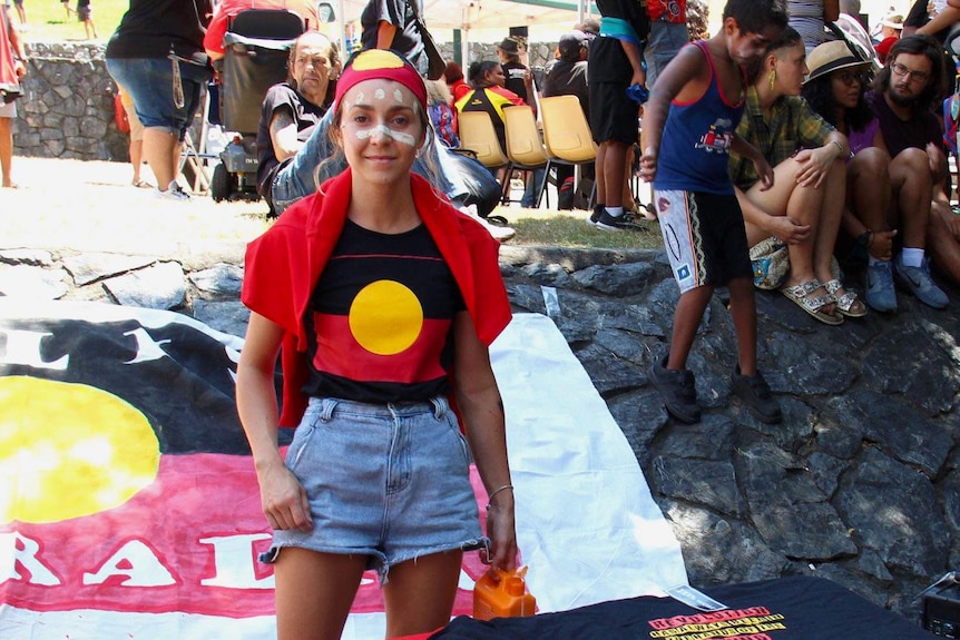 Samantha Martoo wears an Aboriginal flag headband and t-shirt.