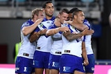 Kerrod Holland celebrates with Bulldogs teammates after his try against Wests Tigers