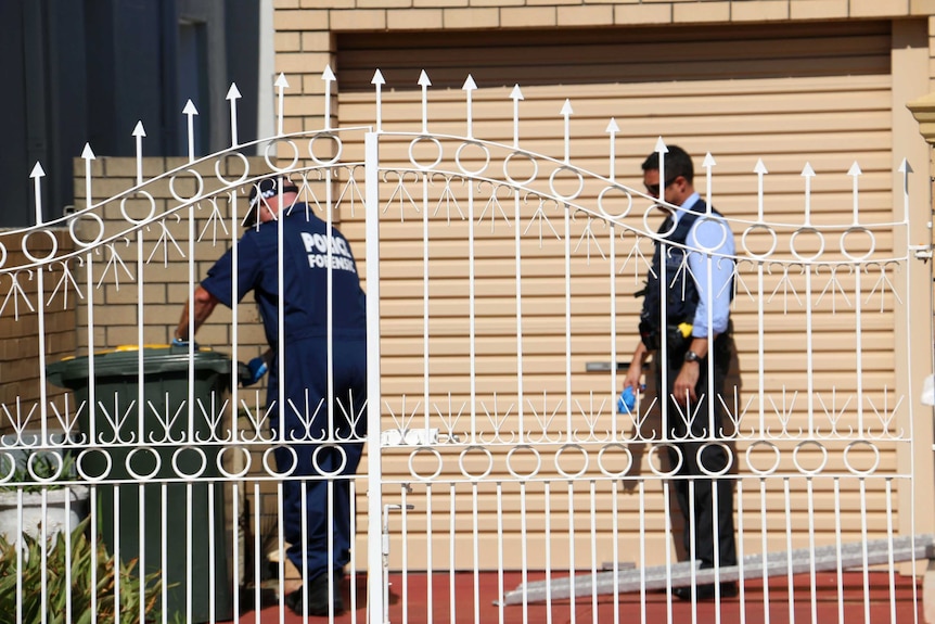 Forensic police check a bin outside a house in Grosvenor Road North Perth in relation to children abducted and sexually assaulted from a child care centre