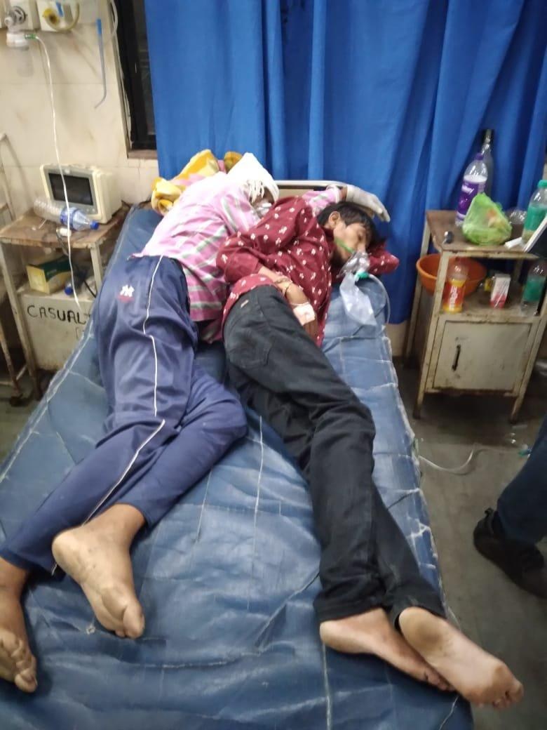 Two men asleep in a hospital bed 