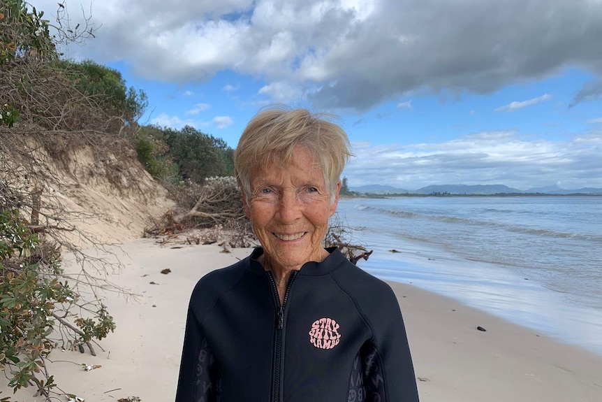 Jan Hayes wears a wetsuit top at Byron Bay's Clarks Beach just before a swim.