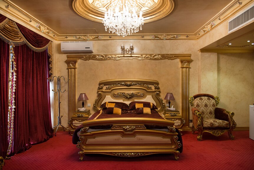 The traditional setting of a bedroom suite at the hotel.