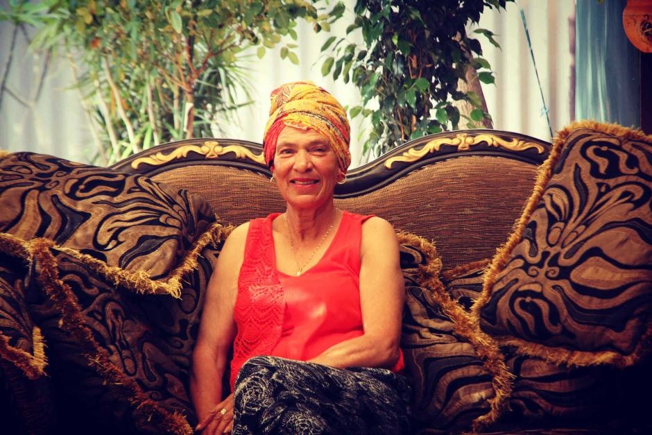'African Queen' Sophie Singh sits on a colourful couch at her Mount Magnet home.