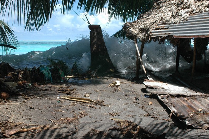 A wave crashing near a structure on Takuu atoll, Papua New Guinea