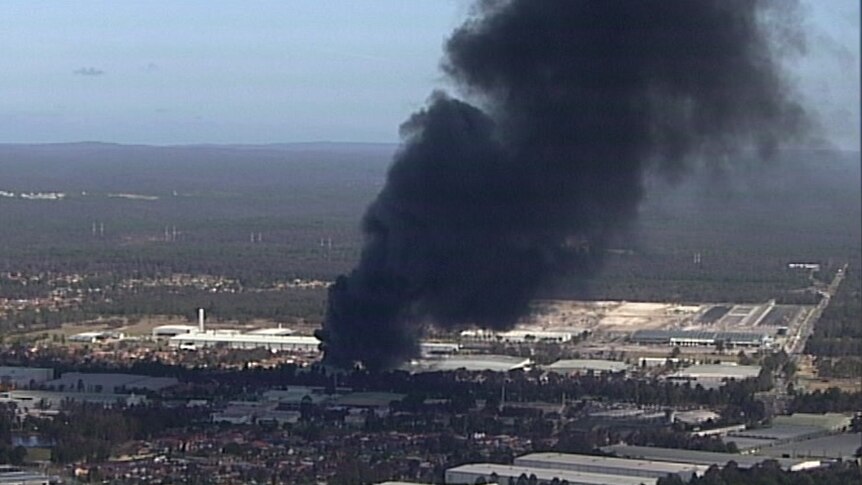 Thick black smoke billowing out of the factory fire at Moorebank.