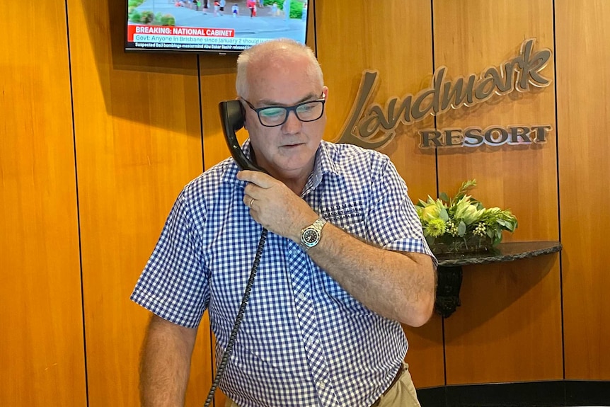 Mooloolaba's Landmark Resort and Spa general manager Brett Thompson talks on the phone.