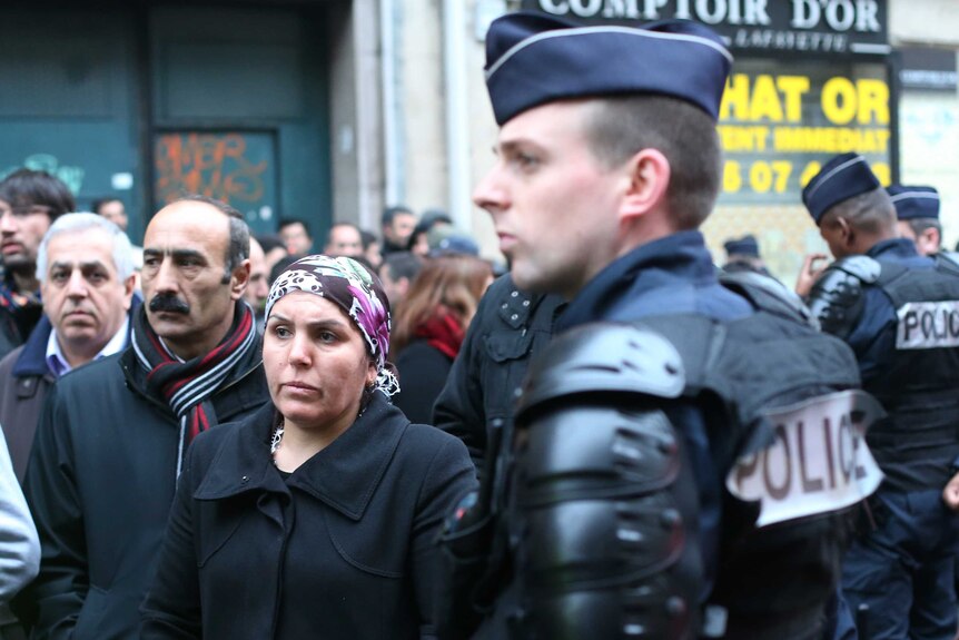 Members of the Kurdish community stand near the Kurdish Institute in Paris.