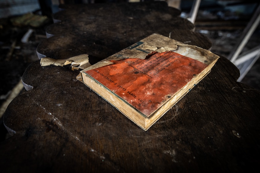 Book with ripped cover on table