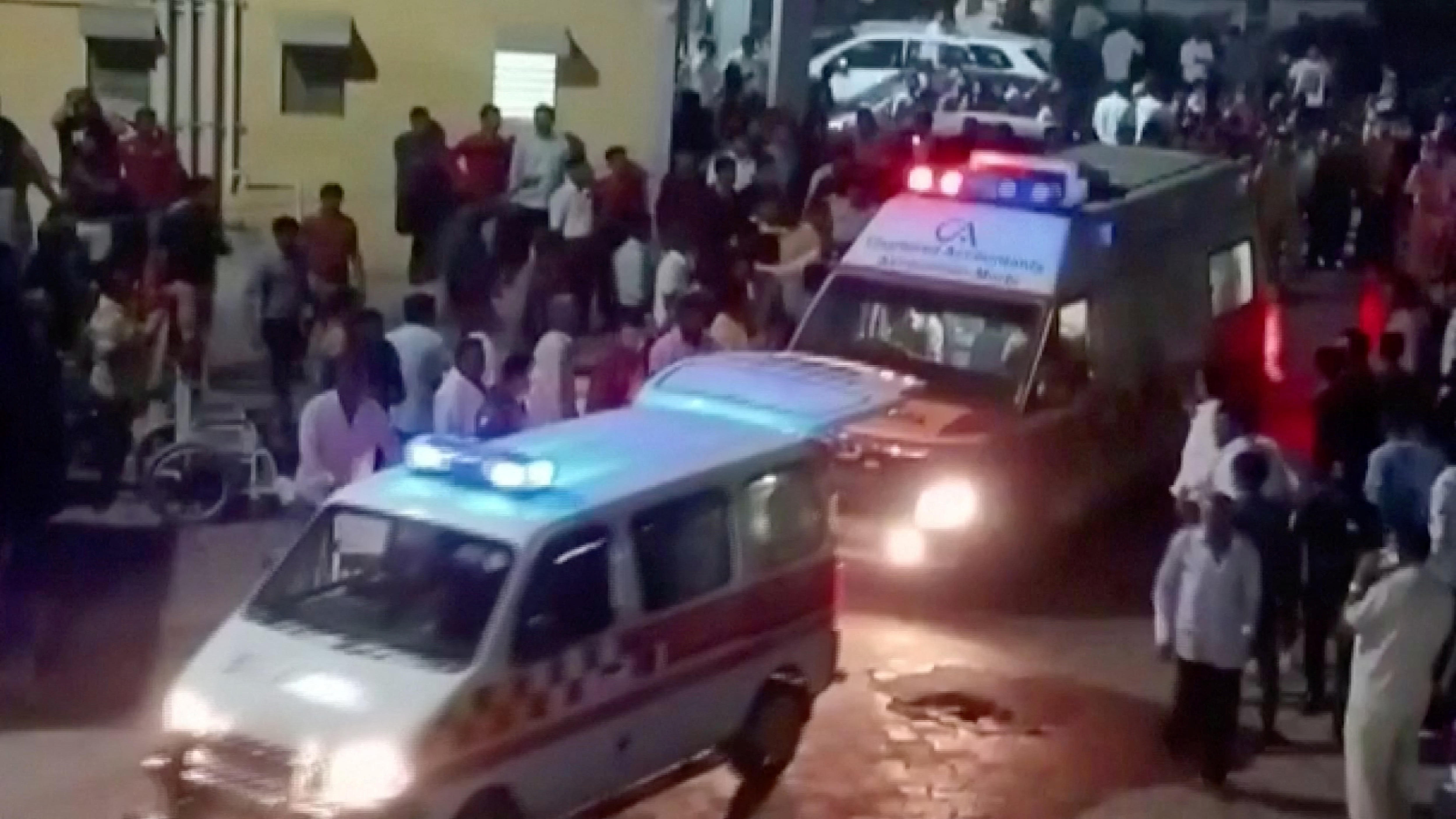Ambulances arrive at a hospital following the collapse of a suspension bridge in Morbi.