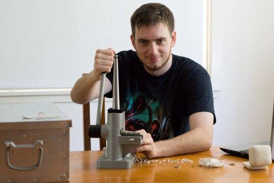 Angus Ewin working at the ring sizing press