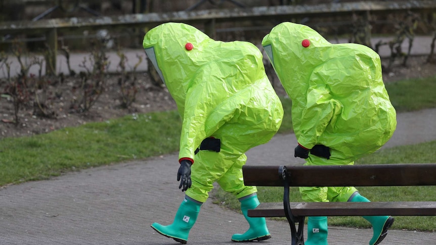 British army personnel wearing bright green protective hazmat suits