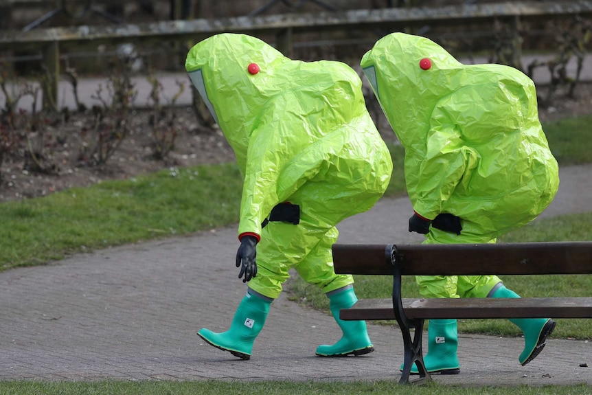 British army personnel wearing bright green protective hazmat suits