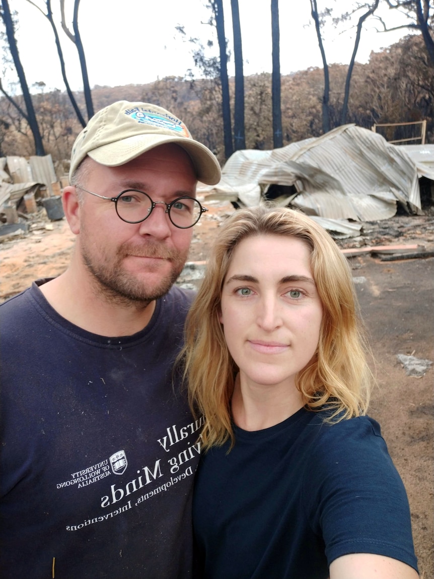 Casey and Michael Kirchhoff in front of the ruins of their home. 