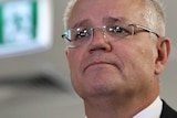 Morrison looks forlorn in front of an exit sign