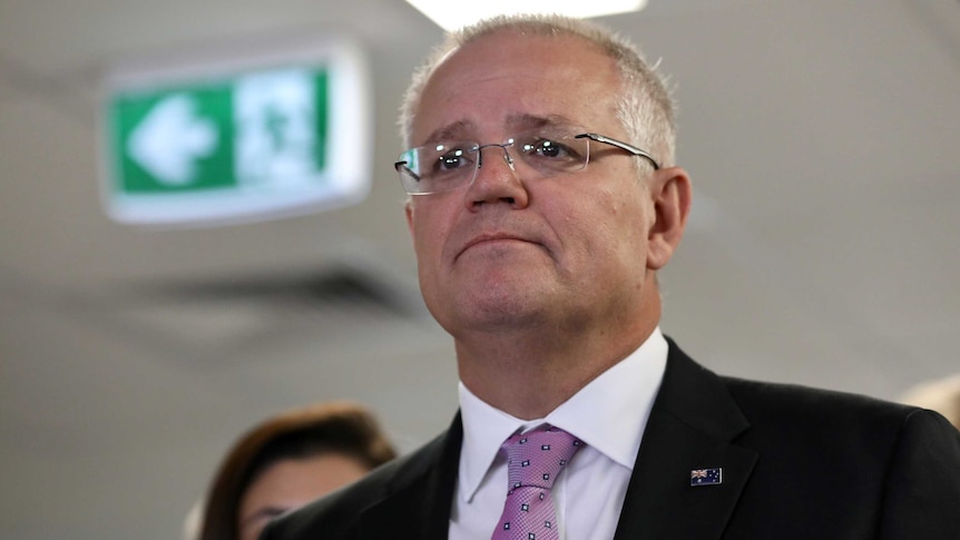 Morrison looks forlorn in front of an exit sign