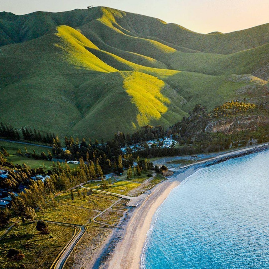 A beach with a hill behind