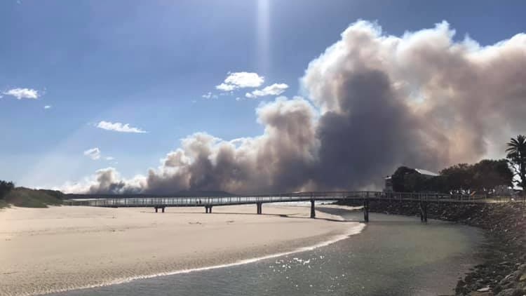 smoke from a bushfire seen from a bridge