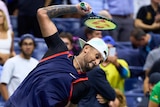 Nick Kyrgios throws a tennis racquet after losing a US Open quarter-final to Karen Khachanov.