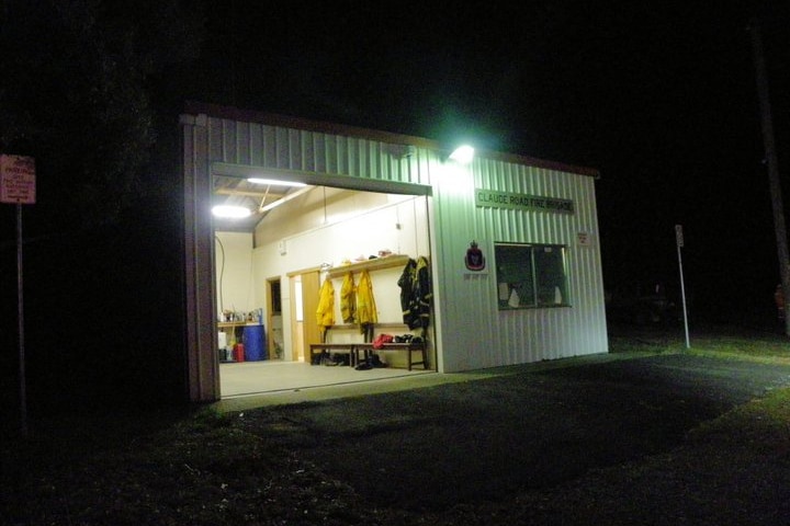 A rural volunteer fire station and uniforms stored near the truck bay