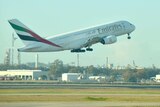 Large Emirates aircraft takes off.
