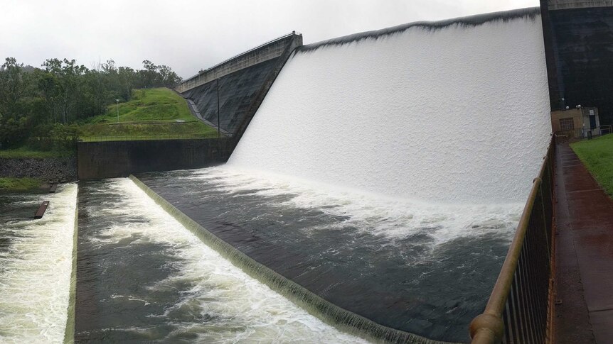 Water flows over the Tinaroo Dam spillway into the Barron River