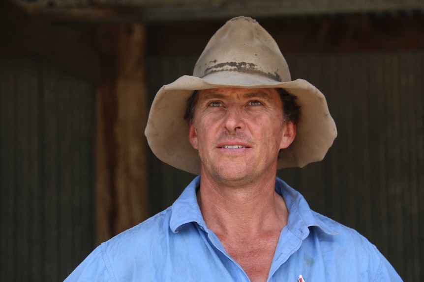 Tom McGuiness walks through his farm.