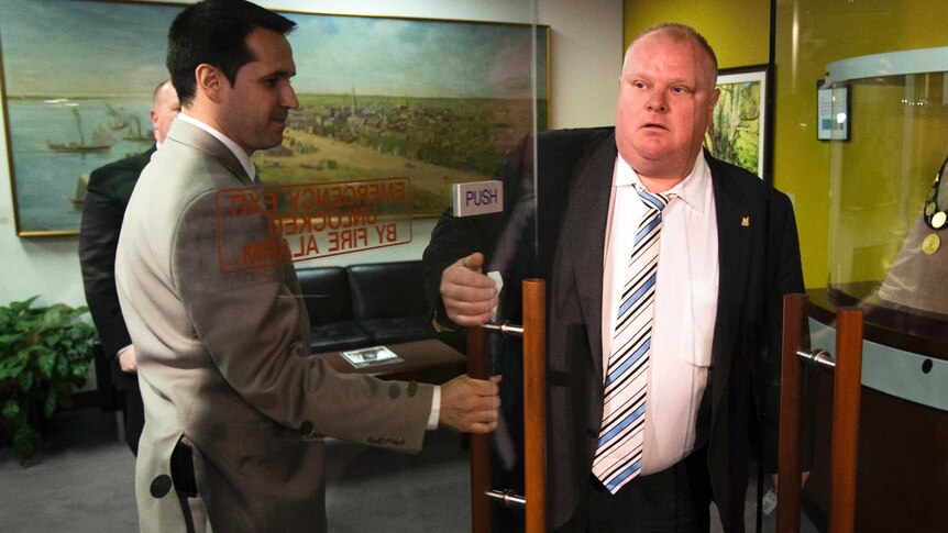 Rob Ford walks out of his office to make a statement.