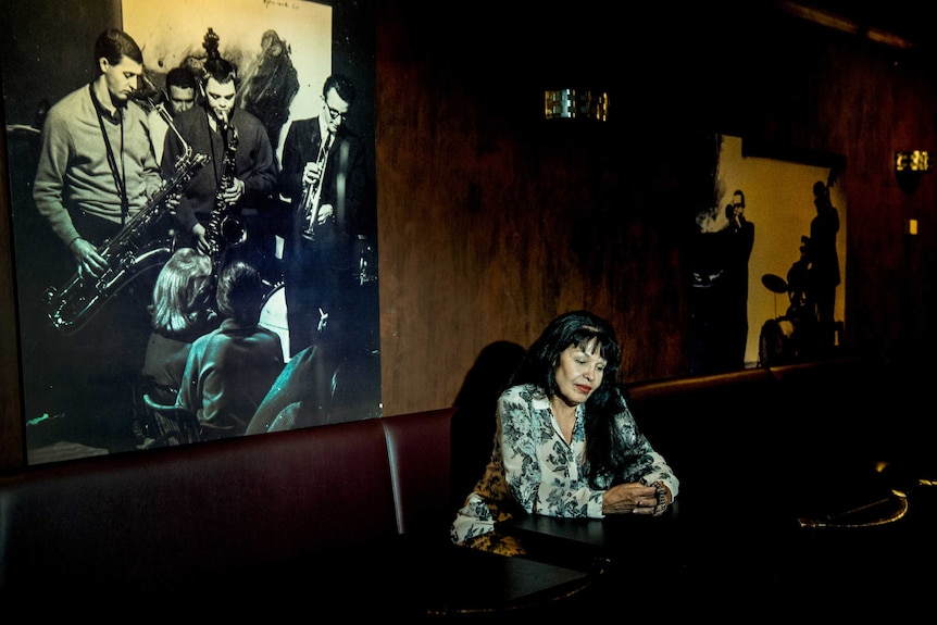 Wilma Reading sitting in a Sydney jazz club staring down at a table.