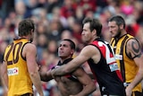 Simon Beaumont for the Hawks (l) clashes with Justin Murphy for the Bombers