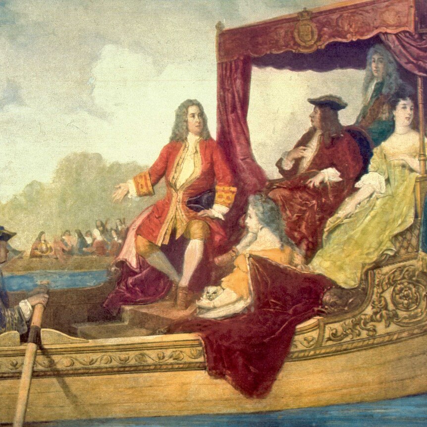 A painting of the composer G.F. Handel on a royal barge, wearing a red coat seated next to King George I and fellow aristocrats.