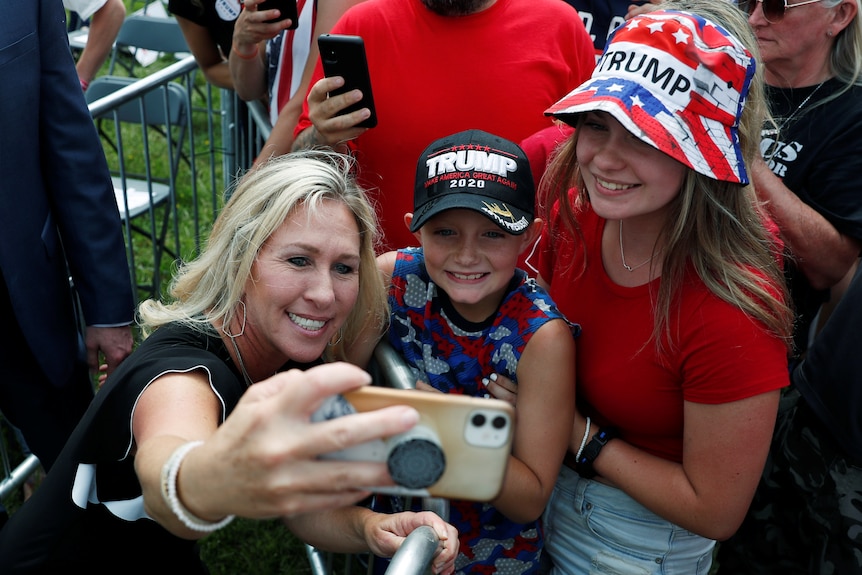 Marjorie Taylor Greene (R-GA) takes a selfie with supporters