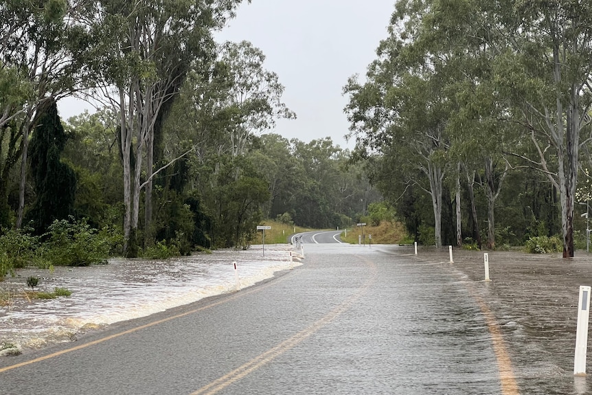 Water flows over a road.