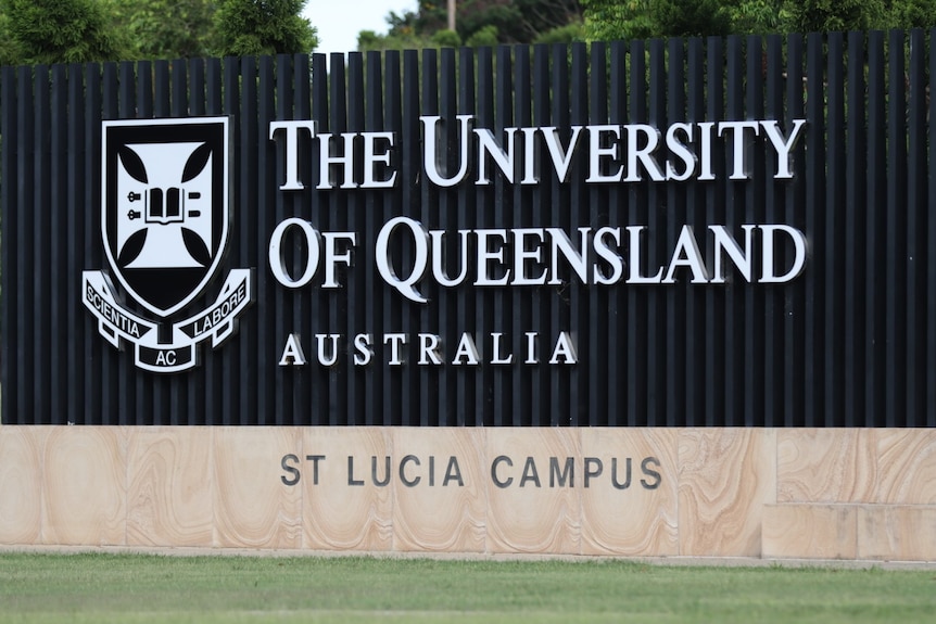 a large stone and steel sign at the entrance to uq that says 'the university of queensland australia st lucia campus'