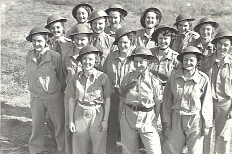 Group of women wearing uniform and helmets