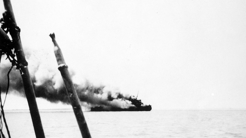 The ship, Zealandia, on fire in Darwin Harbour during the first Japanese raid on Darwin.