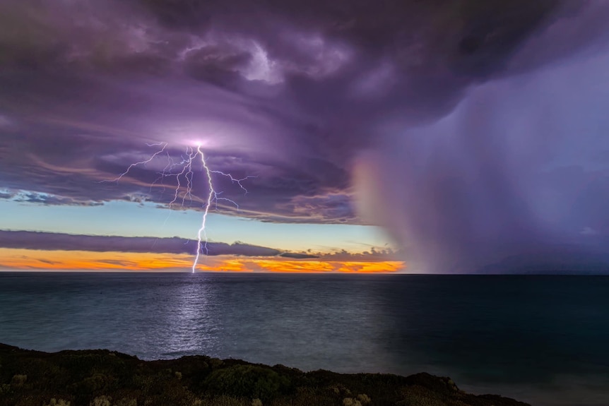 A storm is viewed off a coastal pathway