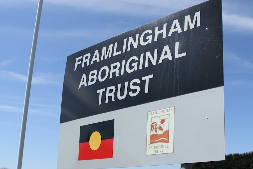 A sign reads Framlingham Aboriginal Trust while an indigenous flag flies in the background.