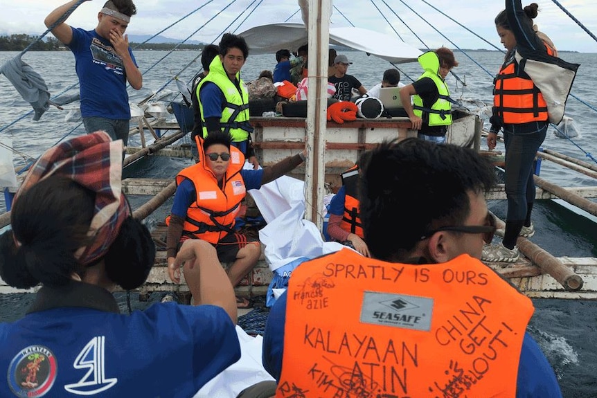 Activists from Kalayaan Atin Ito on a boat
