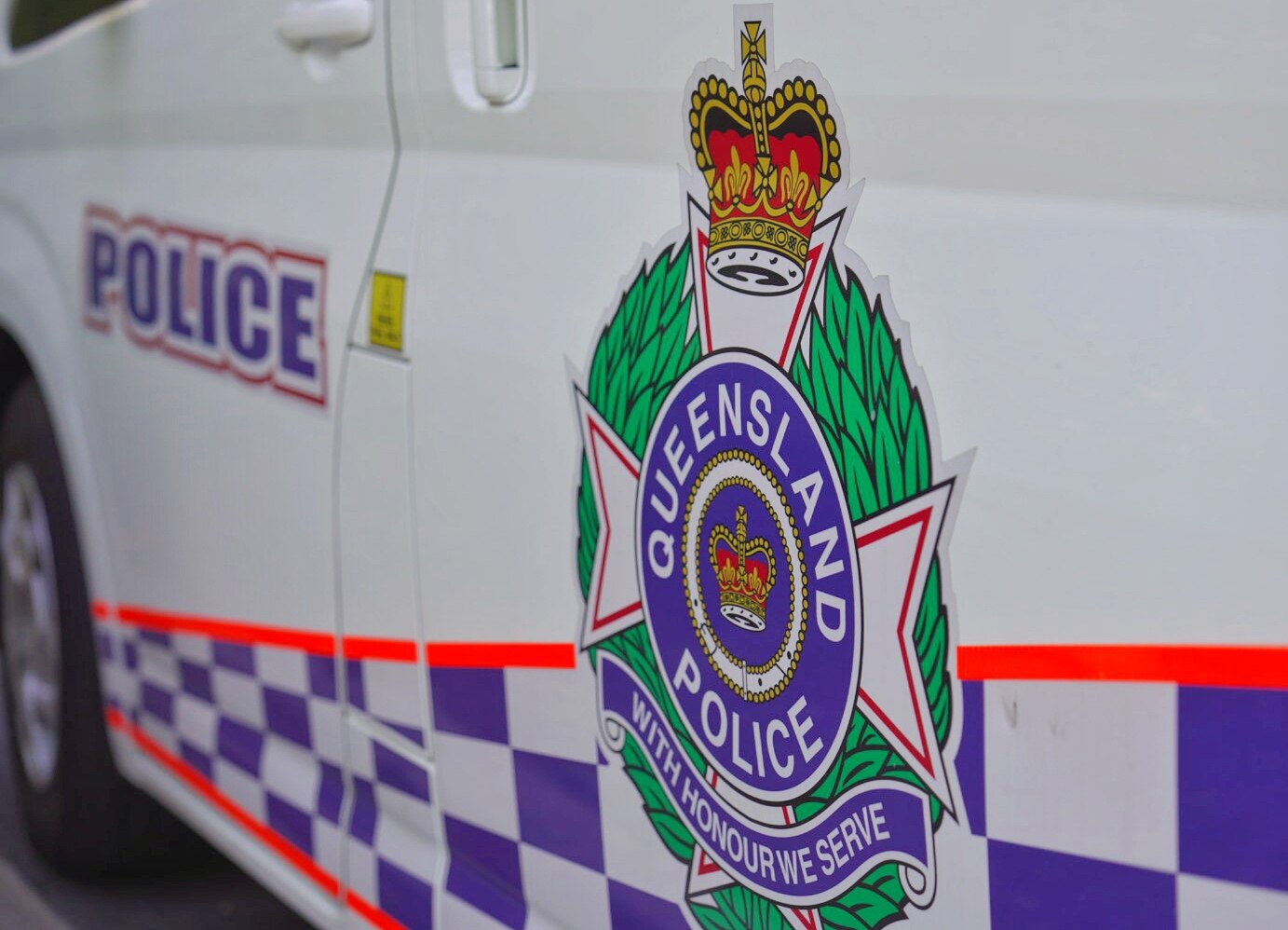 A logo on a vehicle reads "Queensland police".
