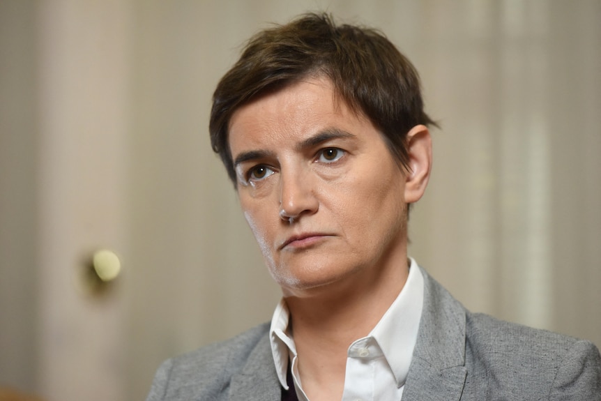 Close up of white woman with short brown hair.