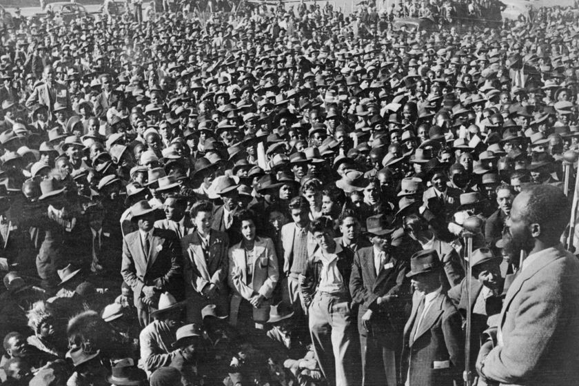 Black and white photo of South Africans at an anti-apartheid rally.