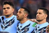 New South Wales players line up during the singing of the anthem before Game I of the 2019 State of Origin series.