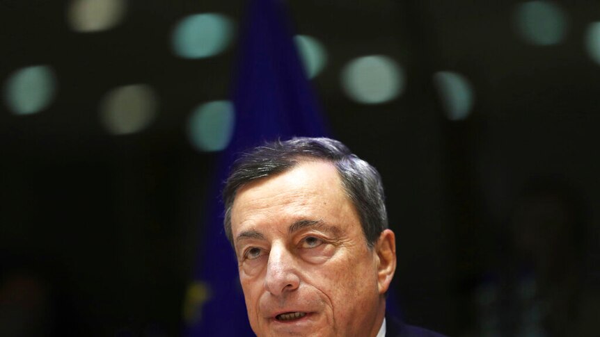 Mario Draghi wearing a suit, mid-speech.