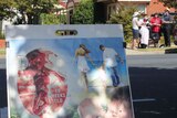 A group of anti-abortion protesters with a graphic poster showing a 10 week old fetus outside a clinic.